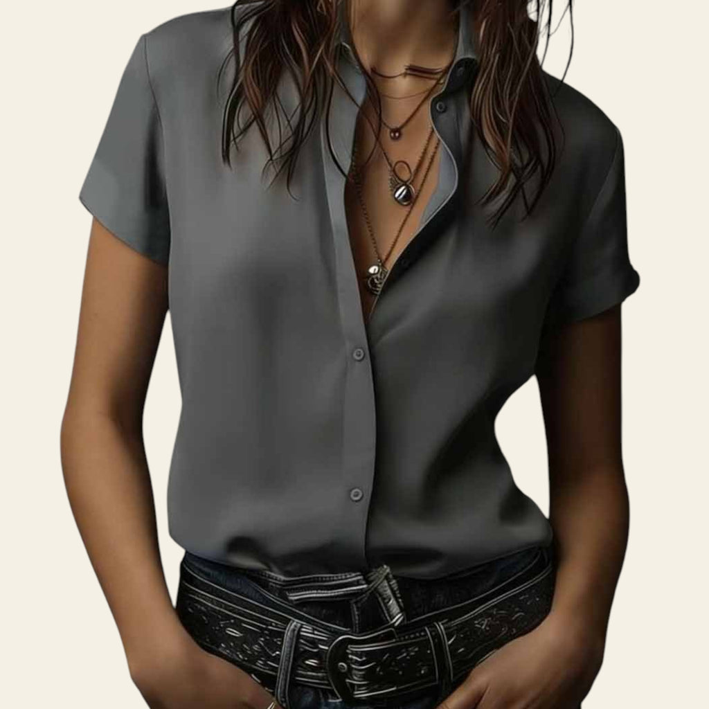 Person wearing a gray shirt with a dark background