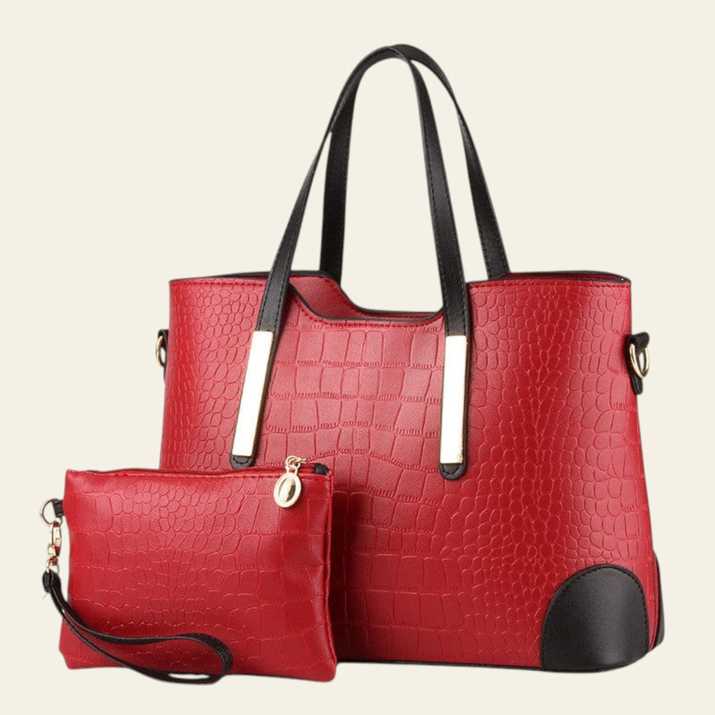 Red textured handbag with black accents and a matching pouch on a white background
