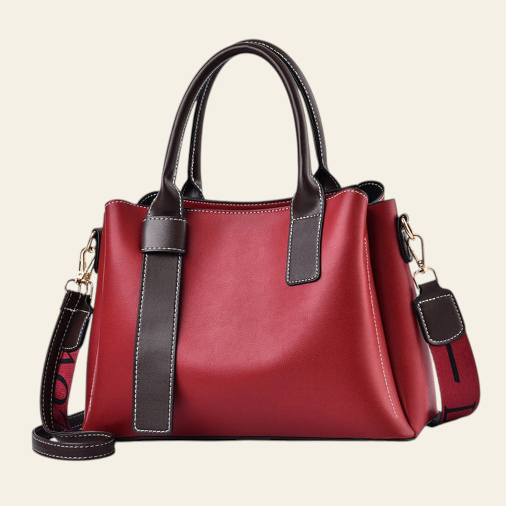 Red handbag with black accents on a white background