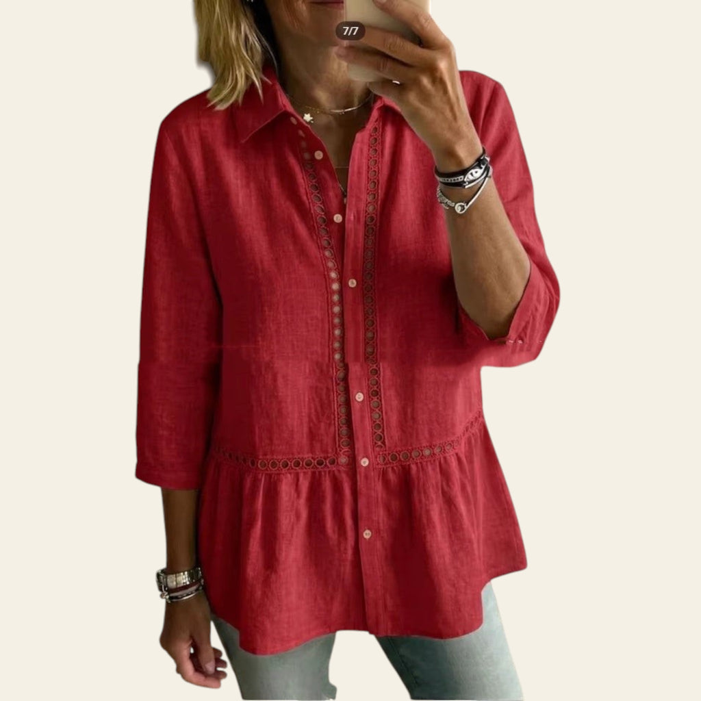Person wearing a red shirt taking a mirror selfie in a living room.