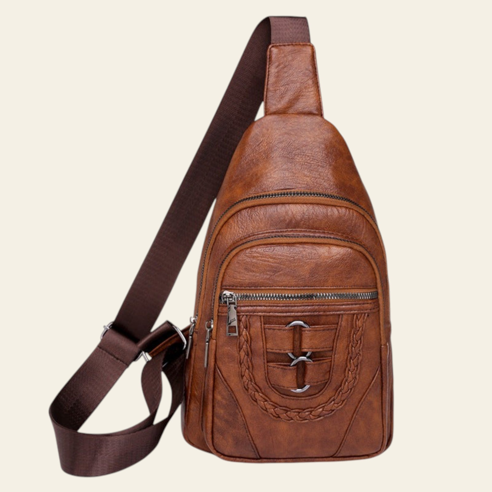 Brown leather sling bag with a buckle on a white background