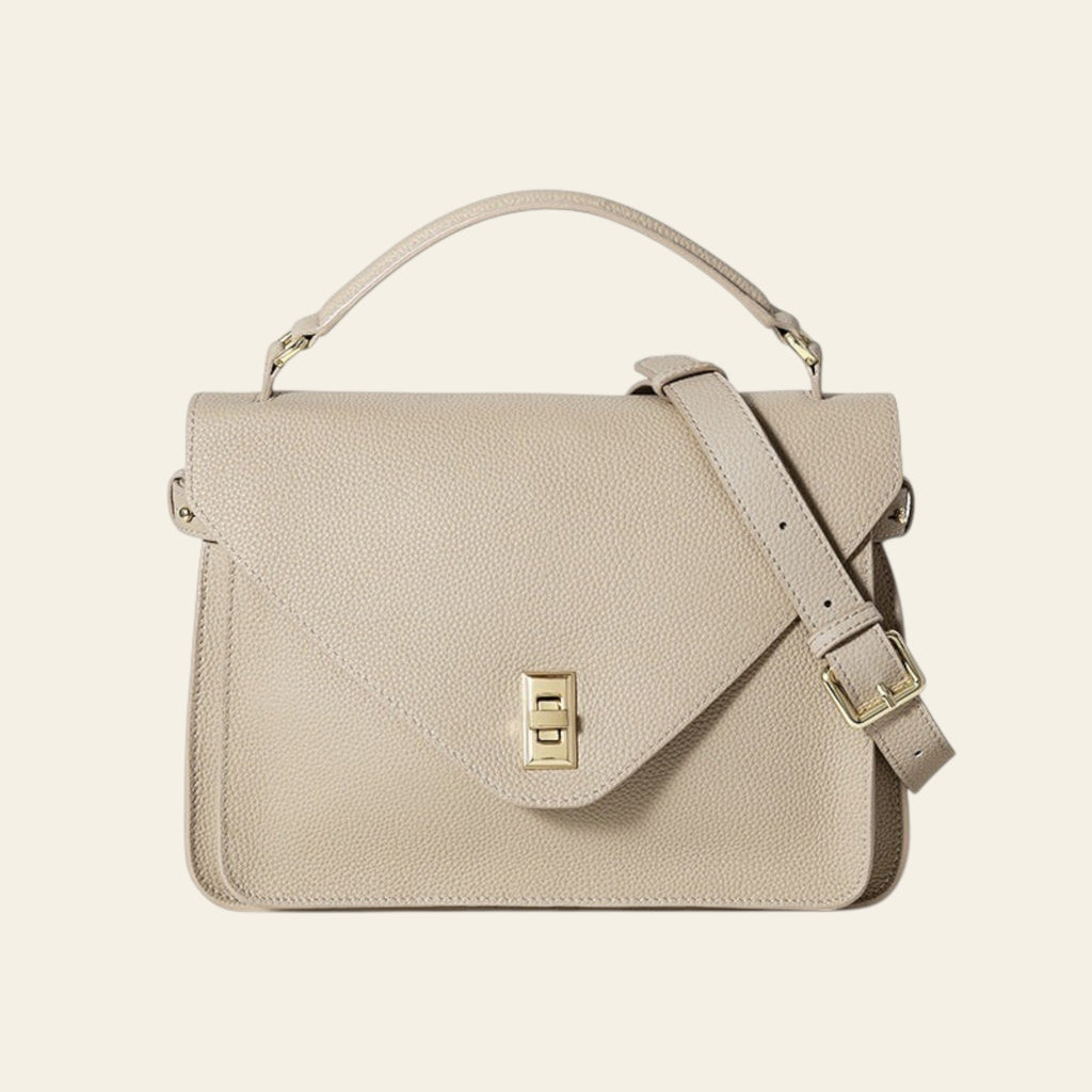 Beige handbag with a gold clasp on a white background