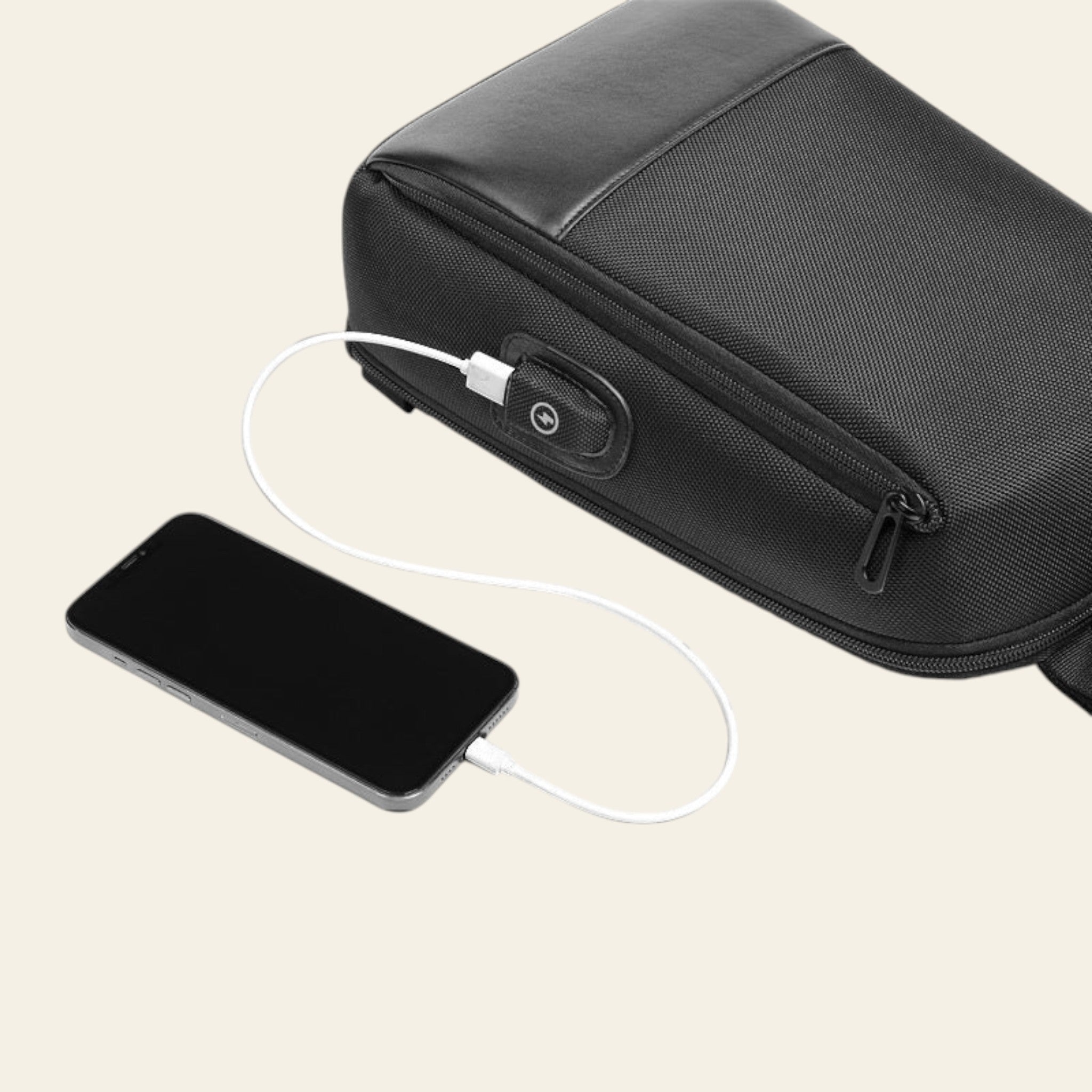 Black backpack with USB port and smartphone being charged on a white background