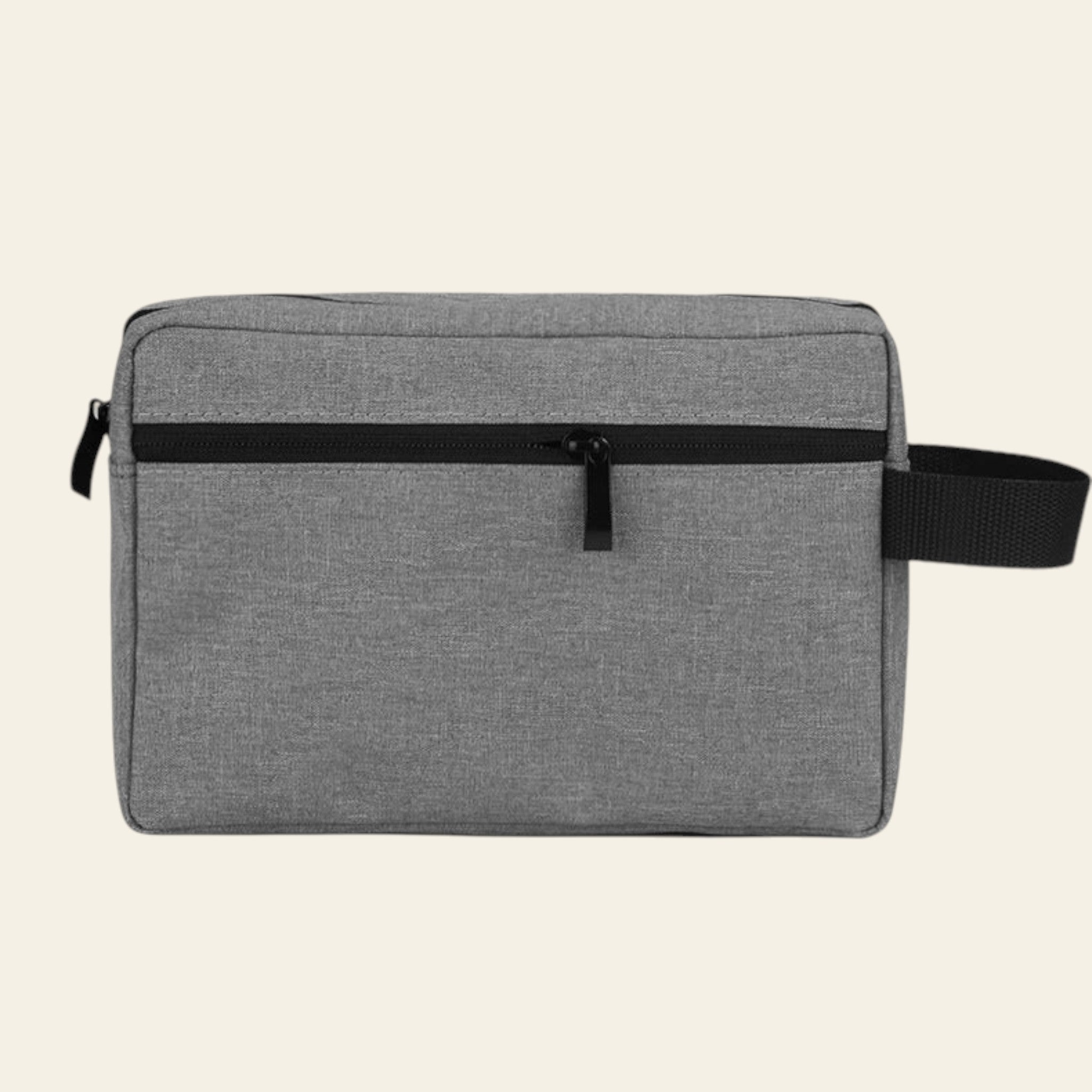 Gray toiletry bag with black strap on a white background