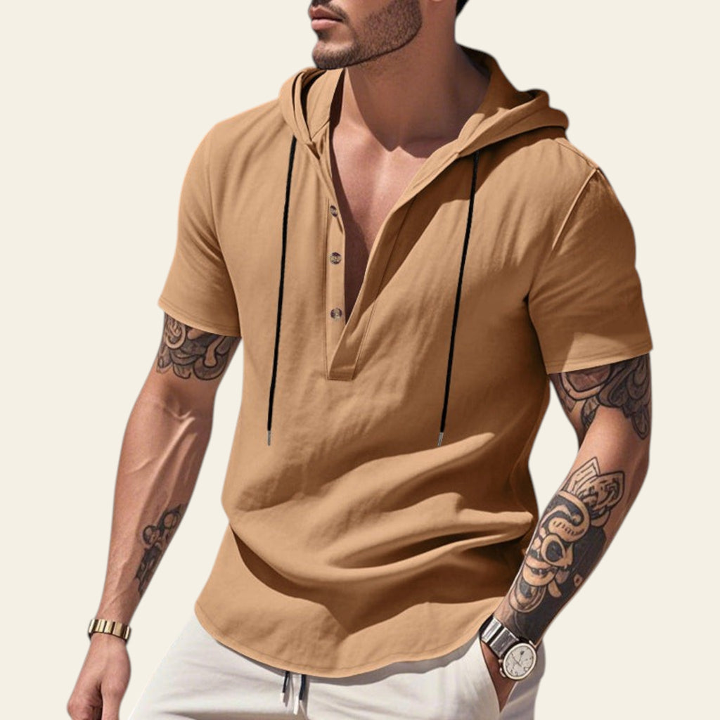 Man wearing a beige breathable linen hooded short sleeve henley shirt at the beach