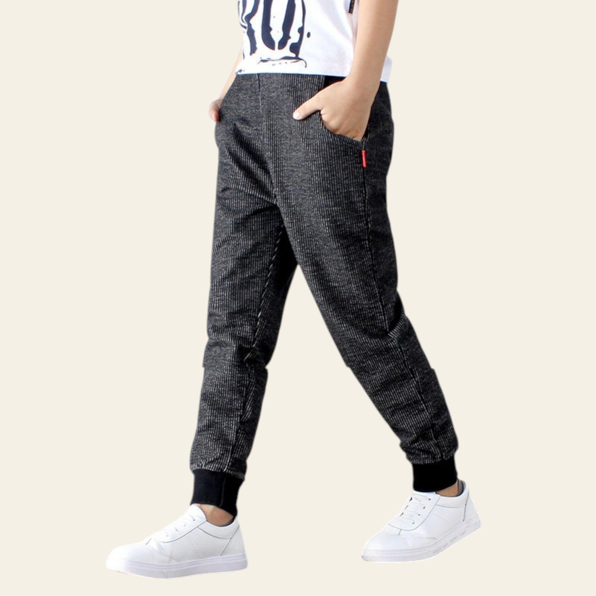 Person wearing dark plaid pants with a white background
