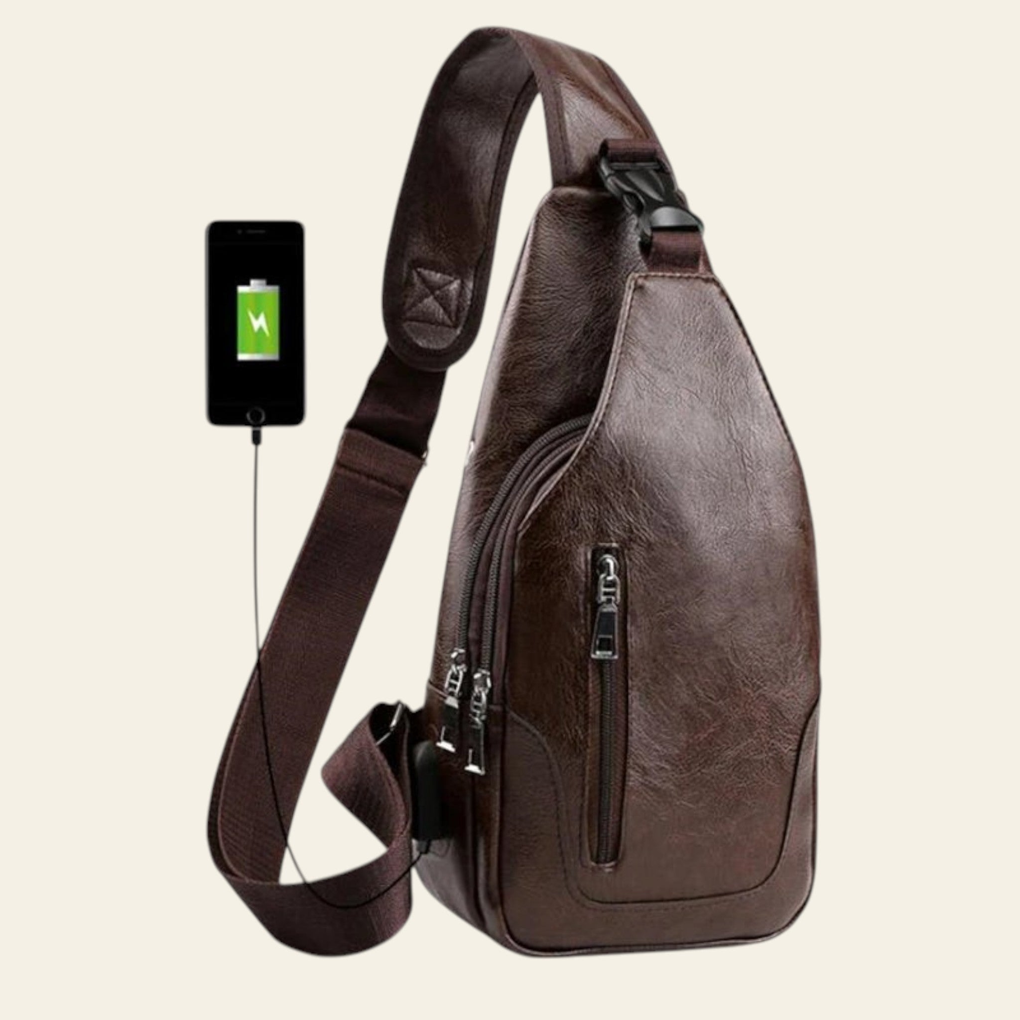 Brown leather sling bag with USB cable and smartphone on a white background