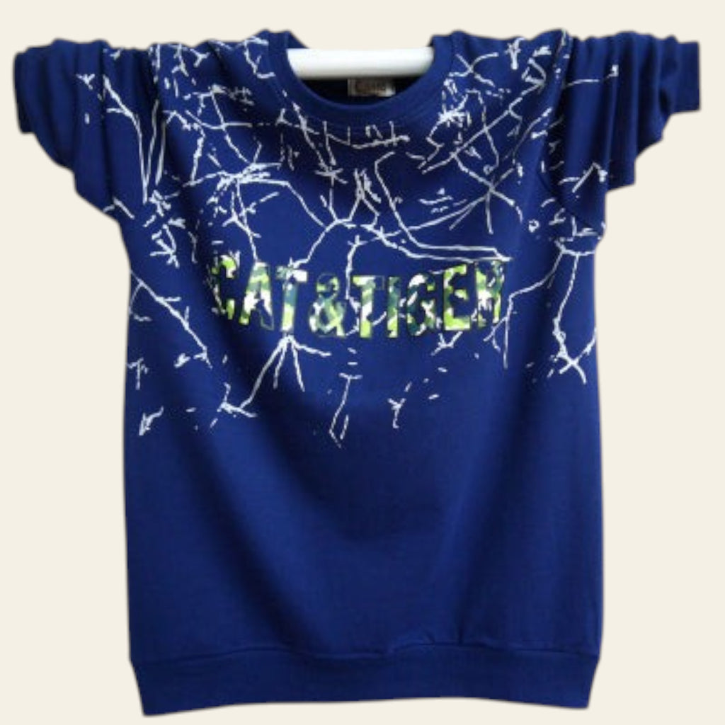 Blue sweatshirt with white abstract design and 'CAT & TIGER' text on a white wooden background