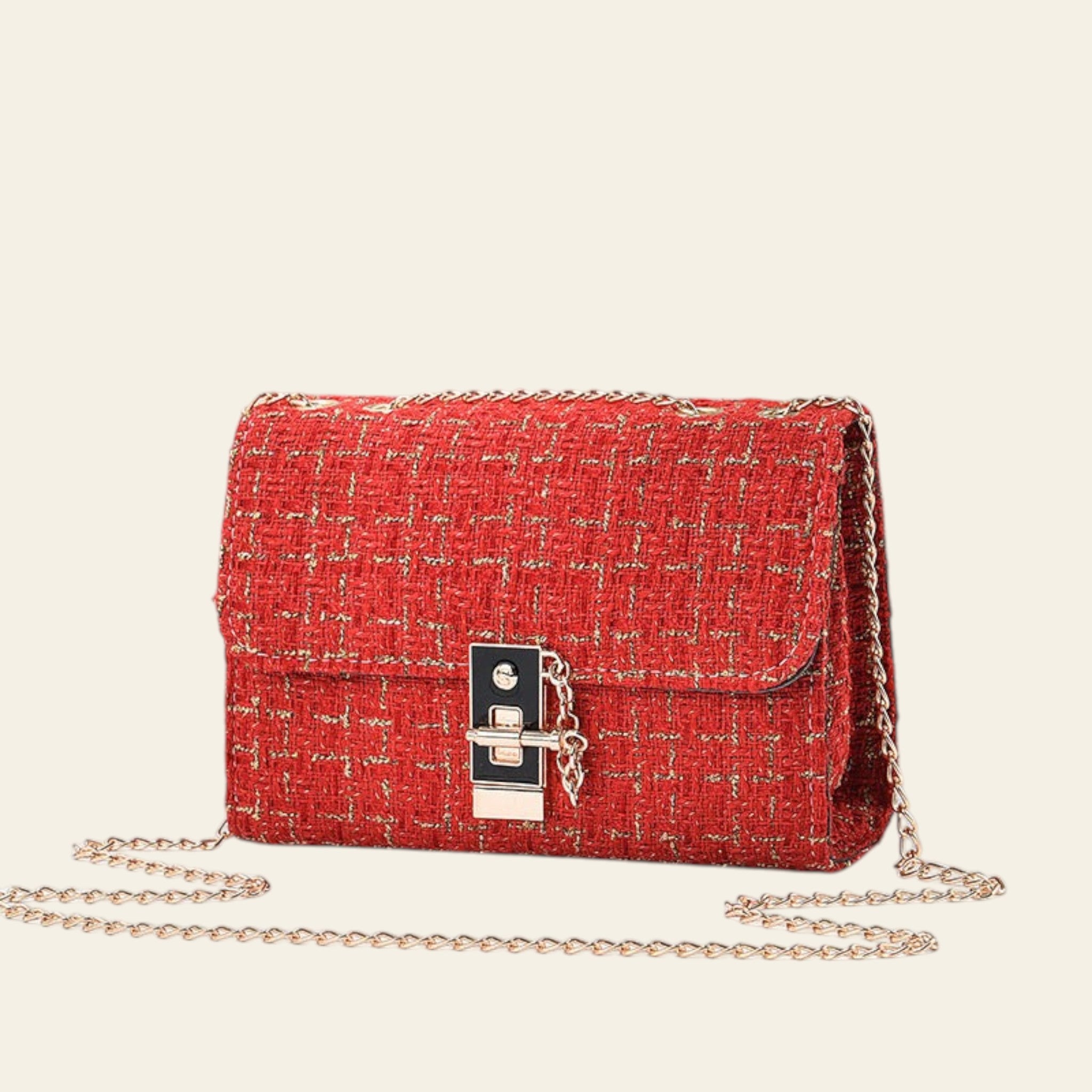 Red textured handbag with gold chain on a light gray background