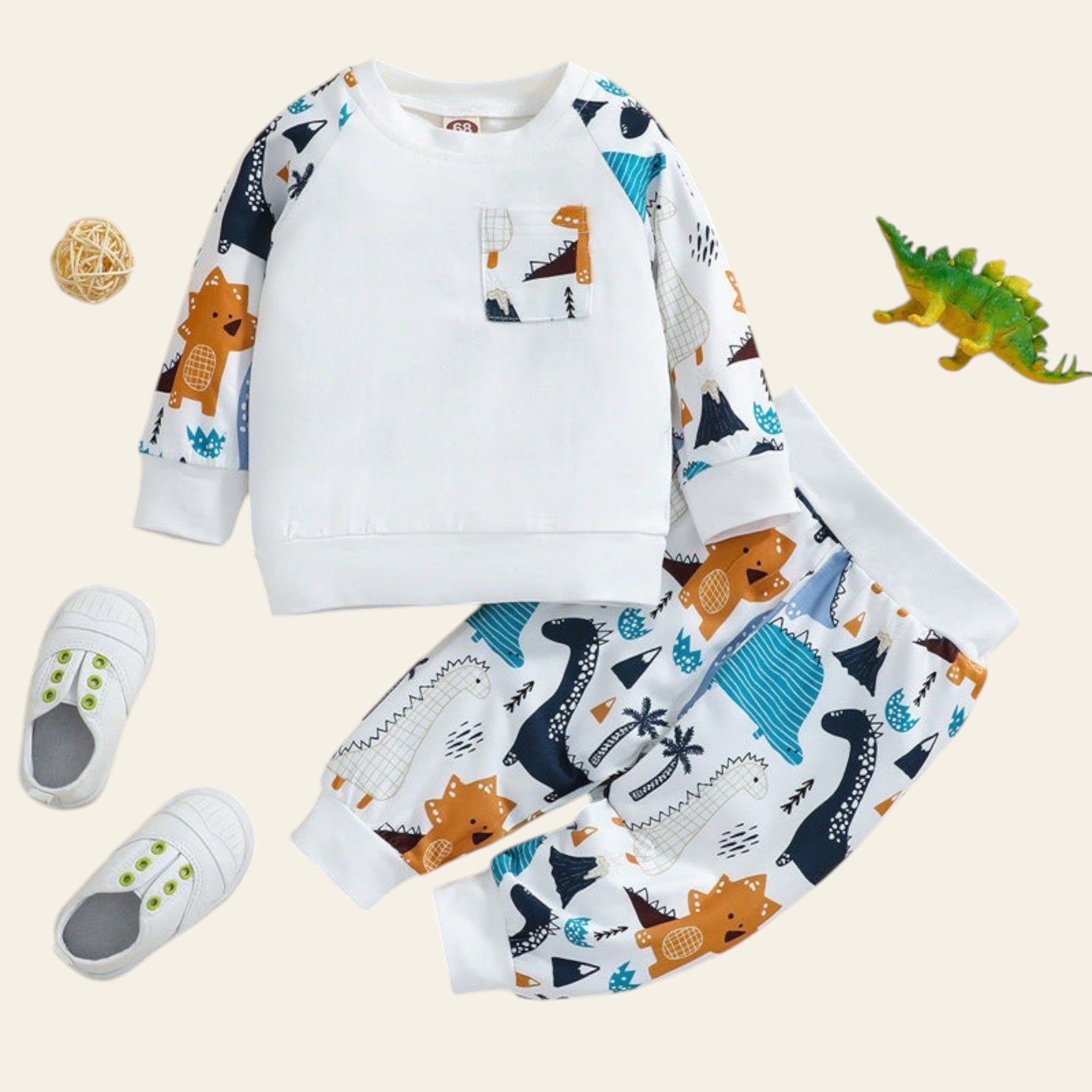 Children's outfit with dinosaur pattern on a beige background