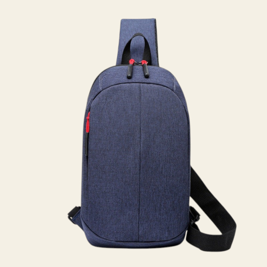 Blue denim crossbody bag with black strap on a white background