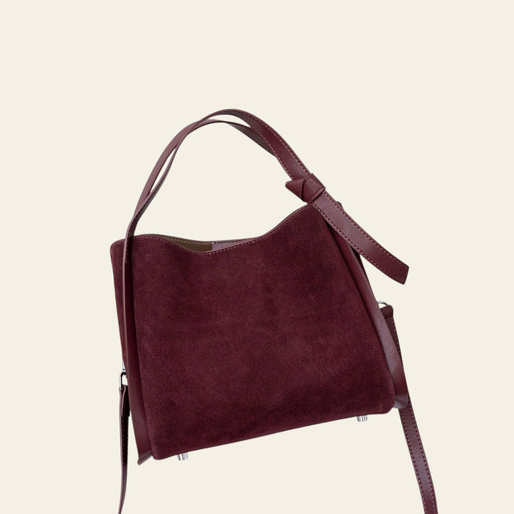 Maroon handbag on a white background