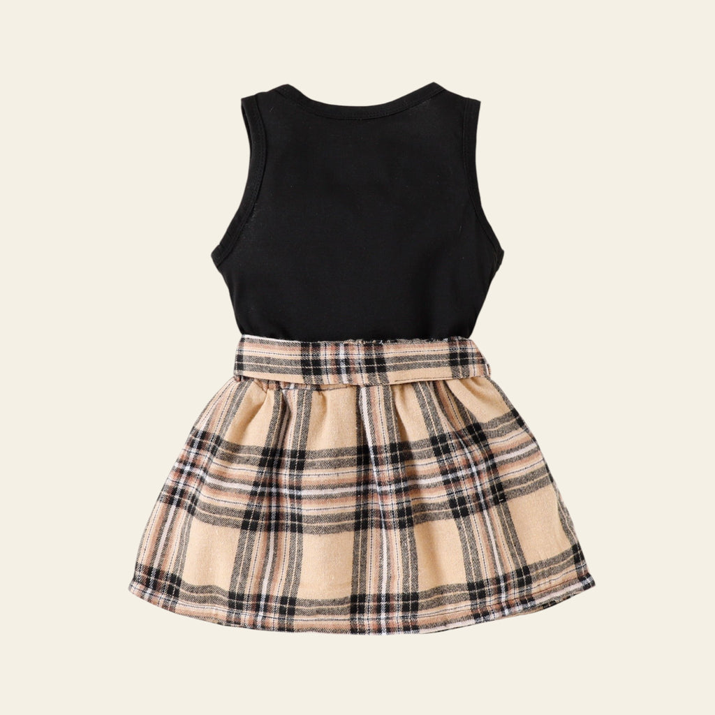 Black sleeveless top and plaid skirt set on a white background