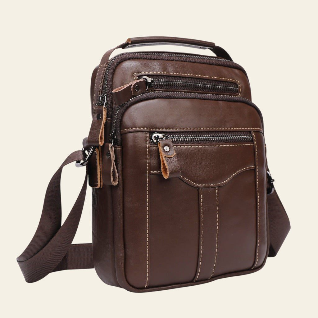 Brown leather crossbody bag on a light gray background