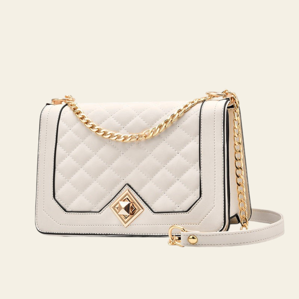 White quilted handbag with gold chain and clasp on a white background