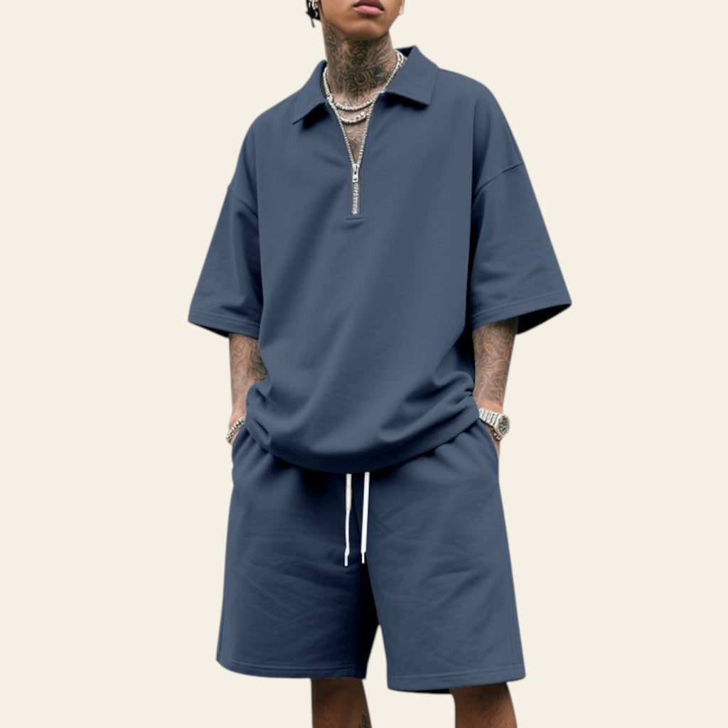 Man wearing a men's summer two-piece set with lapel short sleeve shirt and matching shorts in navy blue color