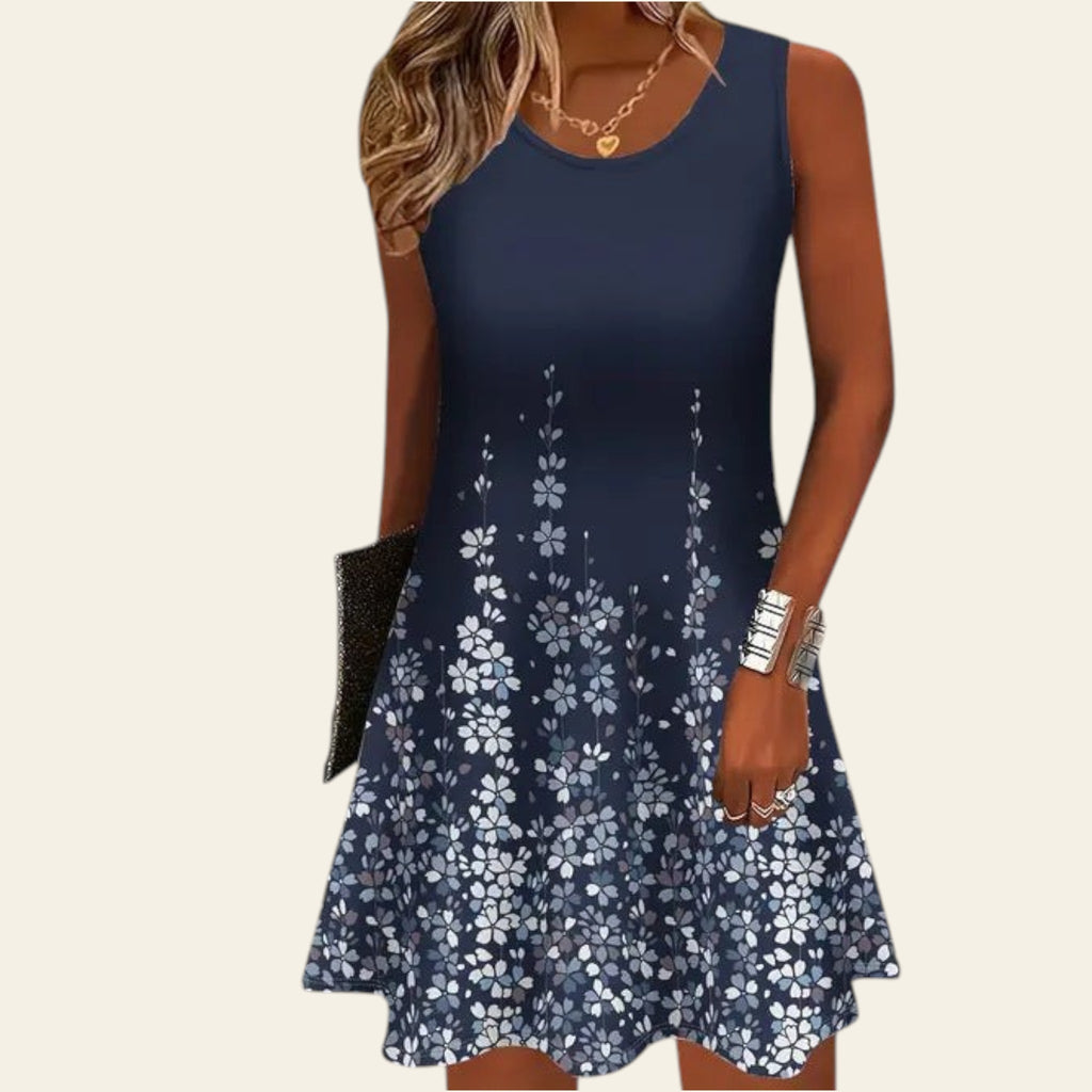 woman wearing a sleeveless navy blue dress with white floral pattern