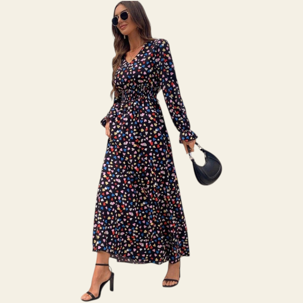 woman wearing a long sleeve floral maxi dress indoors