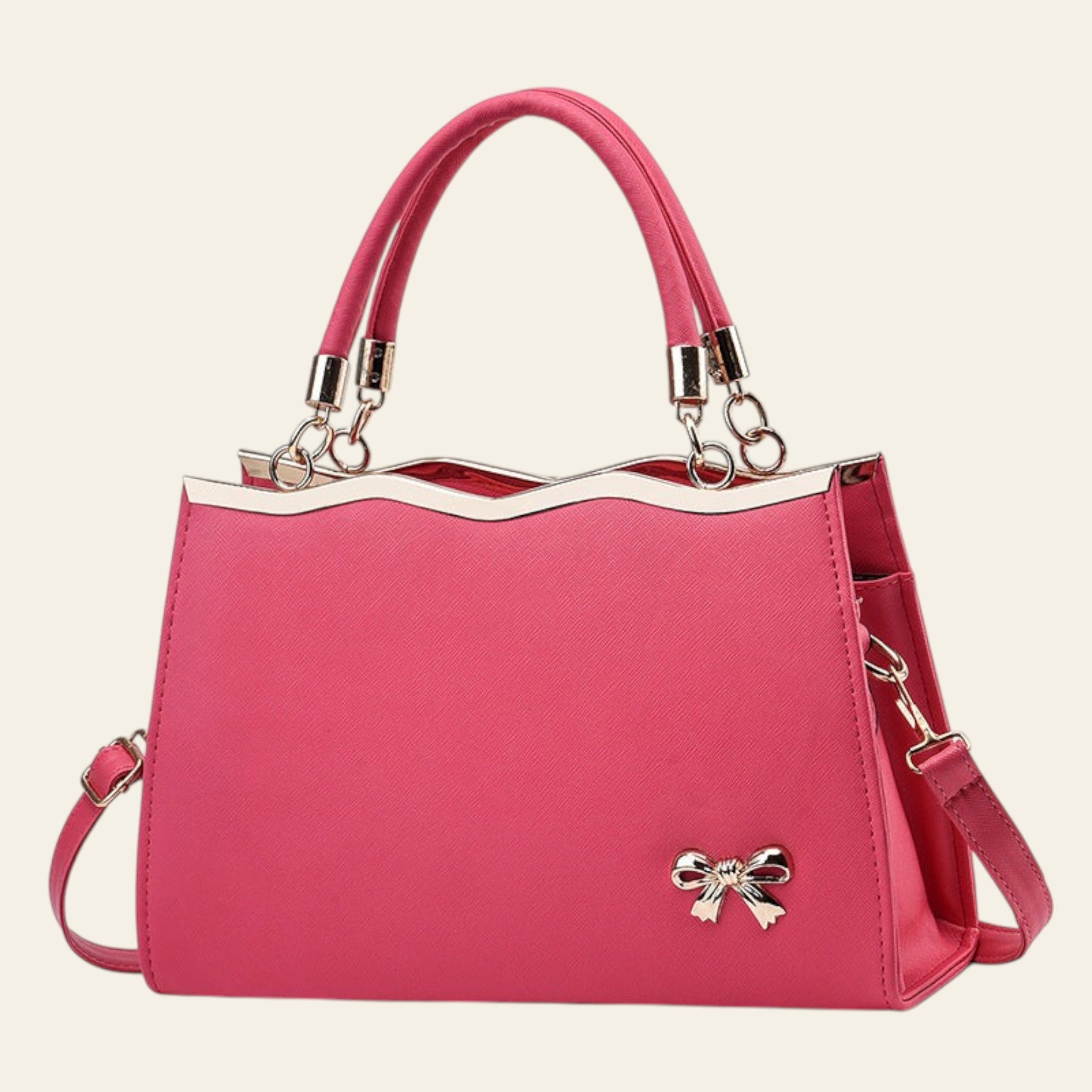 Pink handbag with gold accents on a white background