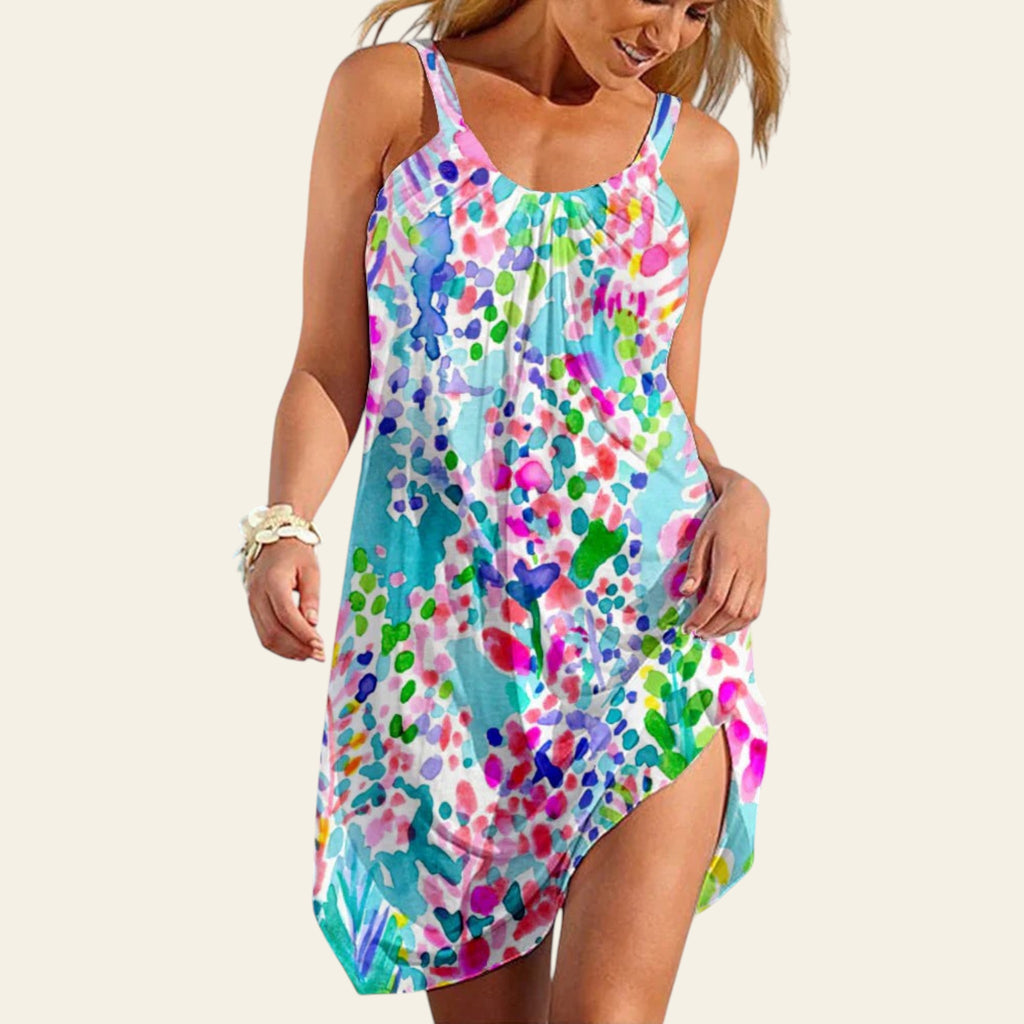 Woman wearing a sleeveless turquoise dress with colorful abstract dot print, summer beach style