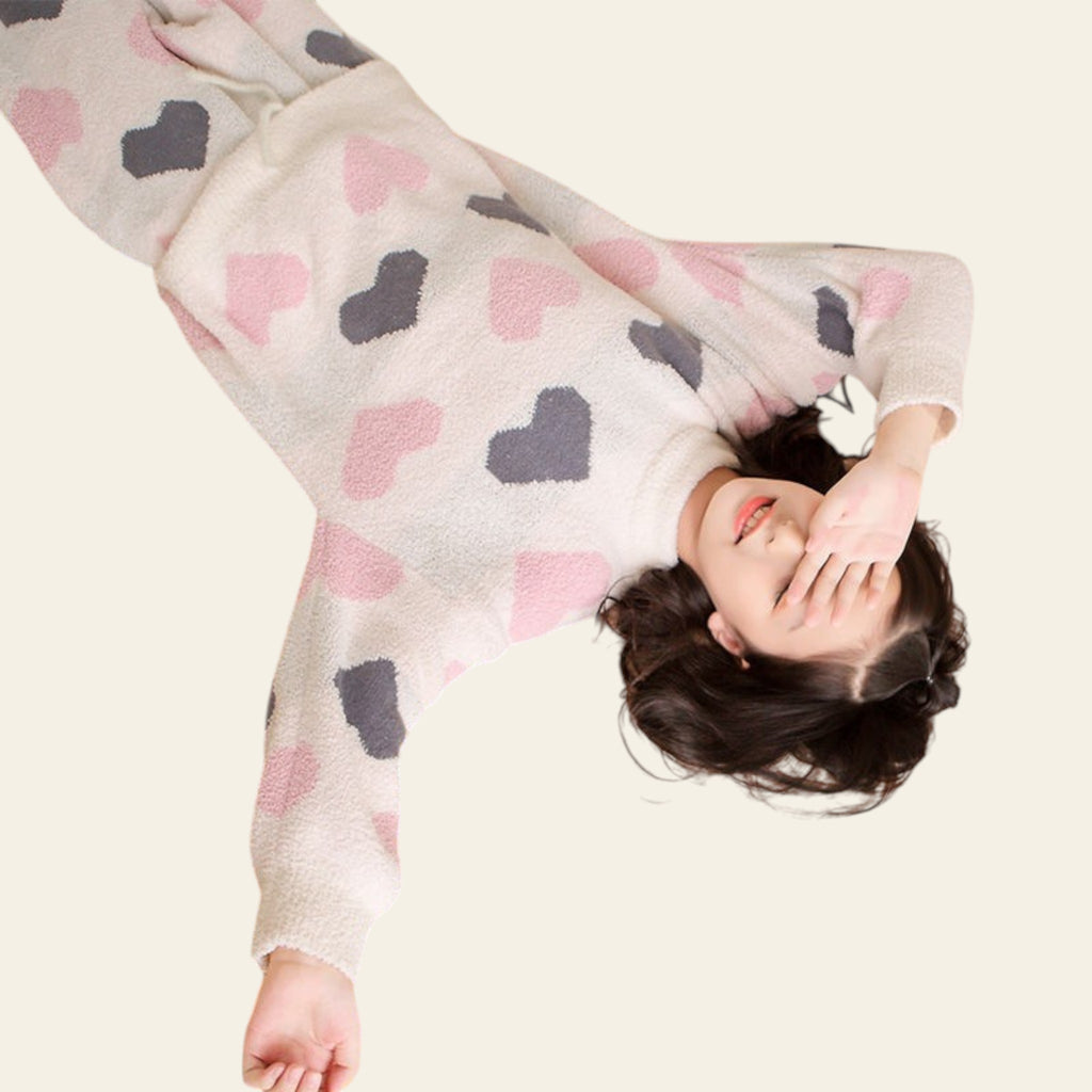 Person lying on a bed with a colorful blanket