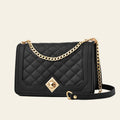 Black quilted handbag with gold chain strap and clasp on a white background