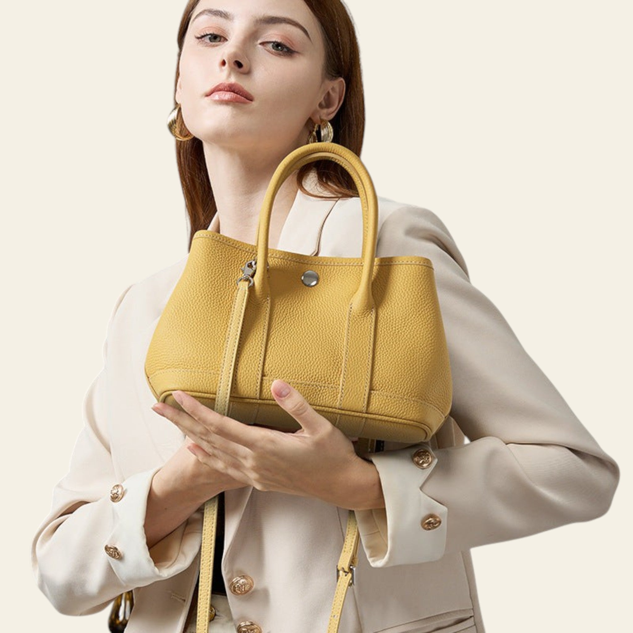 Woman holding a yellow handbag against a neutral background