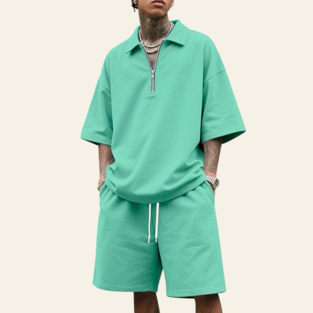 Man wearing a men's summer two-piece set with lapel short sleeve shirt and matching shorts in green color