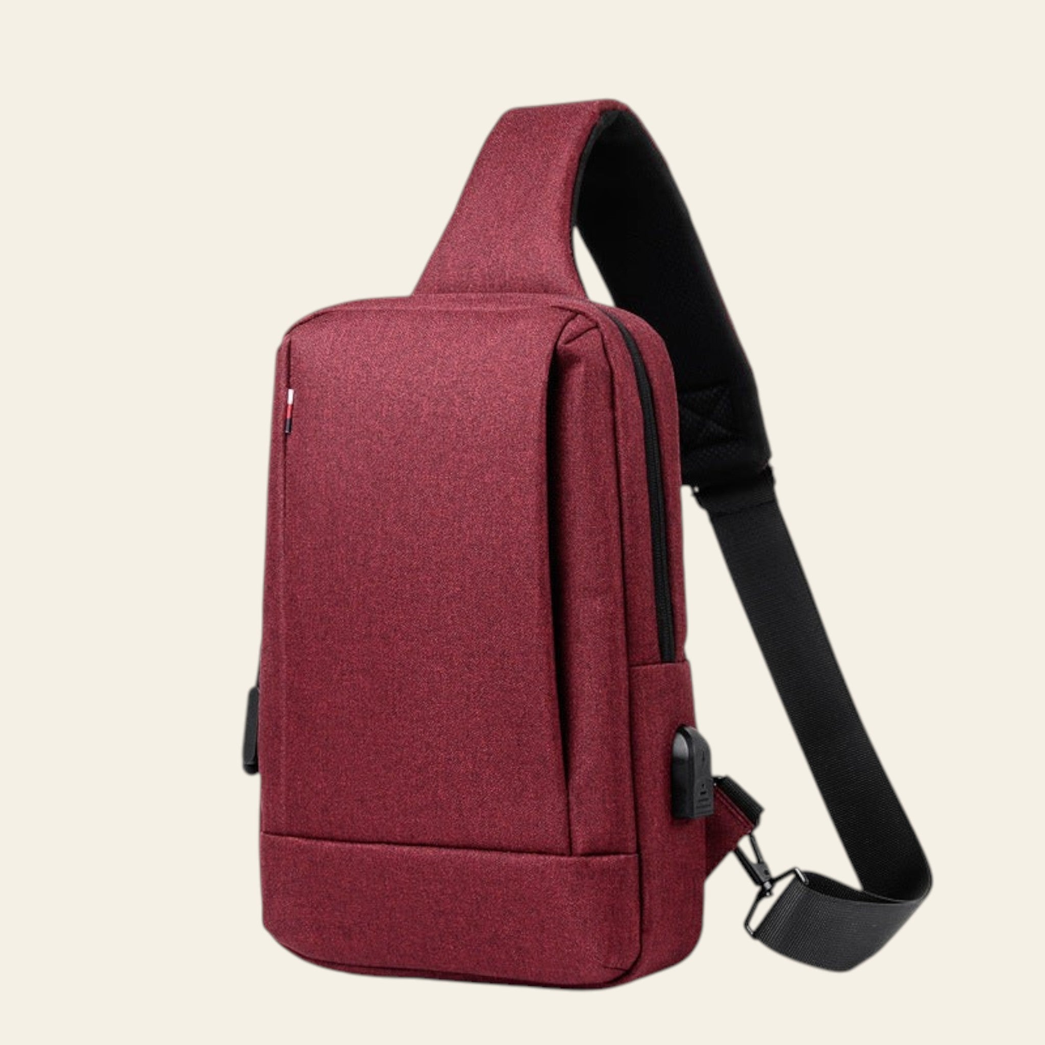 Red sling bag with a black strap on a white background