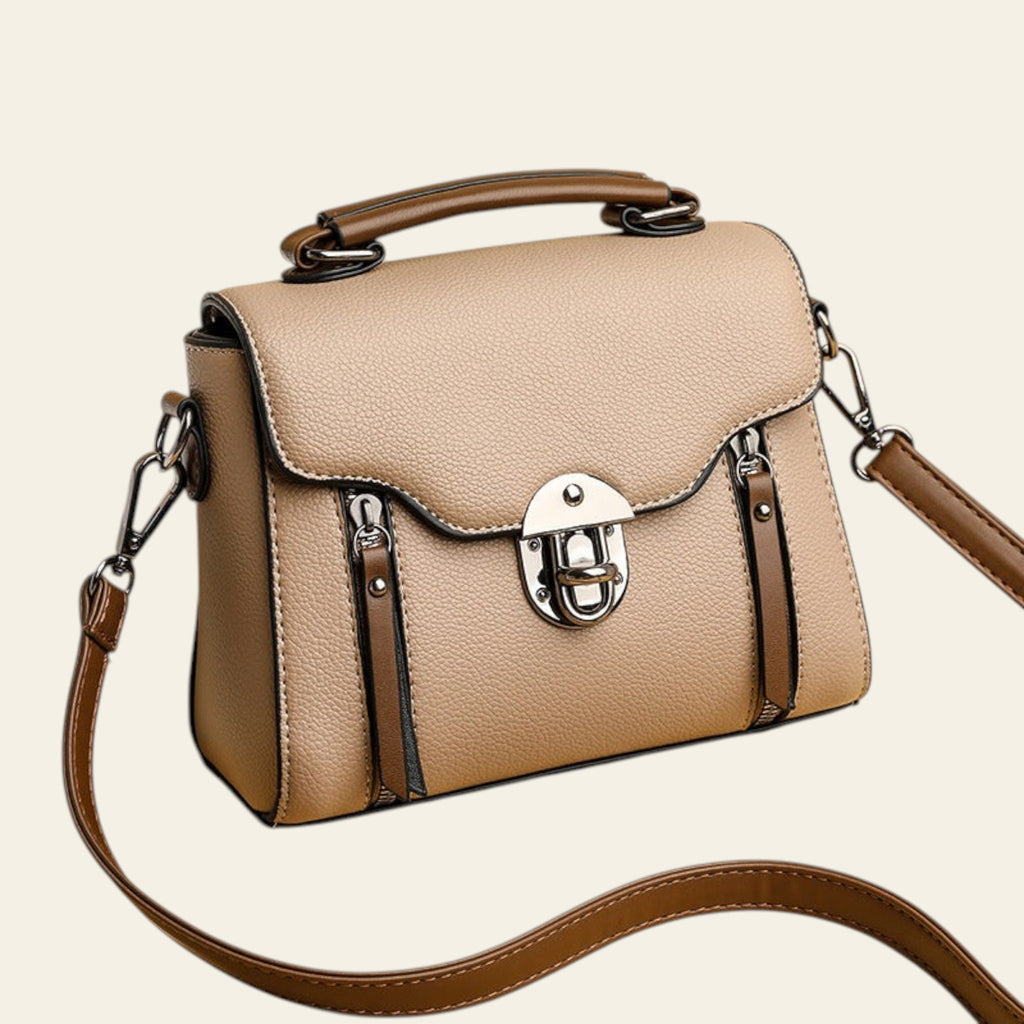 Beige handbag with brown strap on a beige background
