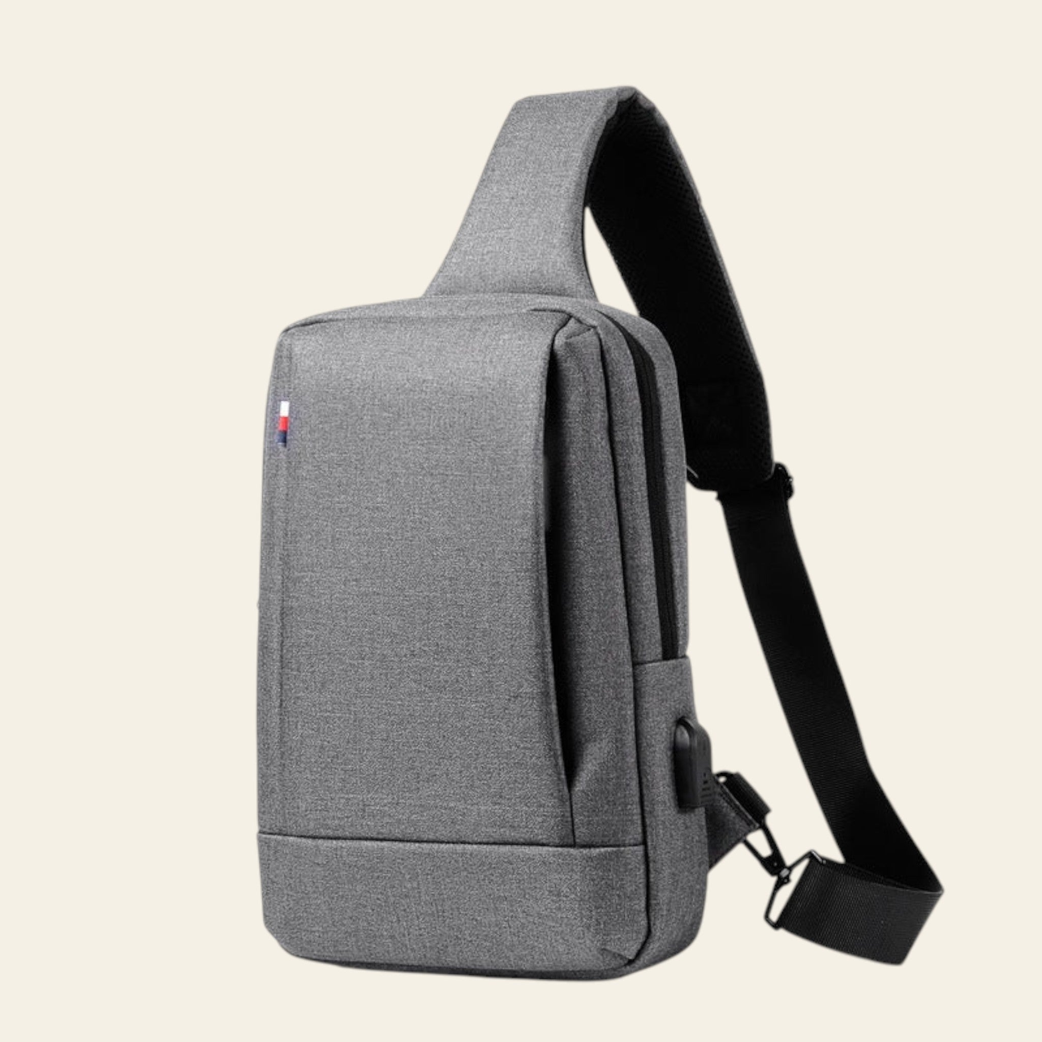 Gray shoulder bag with a strap on a white background