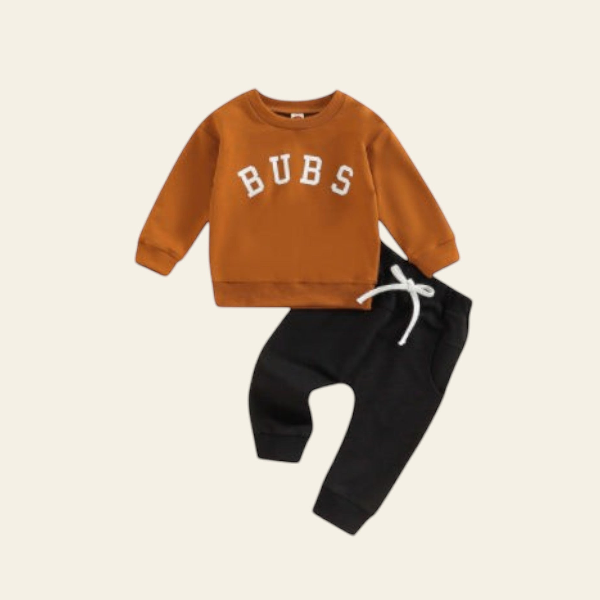 Children's outfit with brown sweatshirt and black pants on a white background
