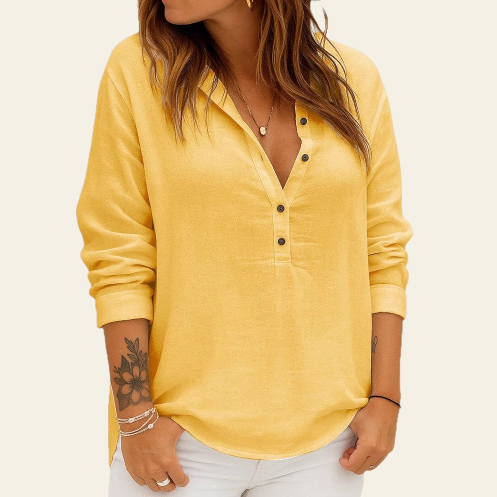 Yellow long-sleeve shirt worn by a person on a white background