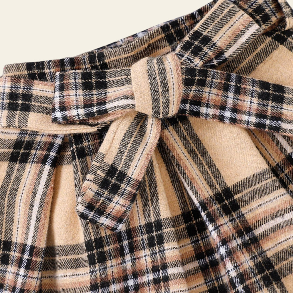 Plaid dress with a bow detail on a light background