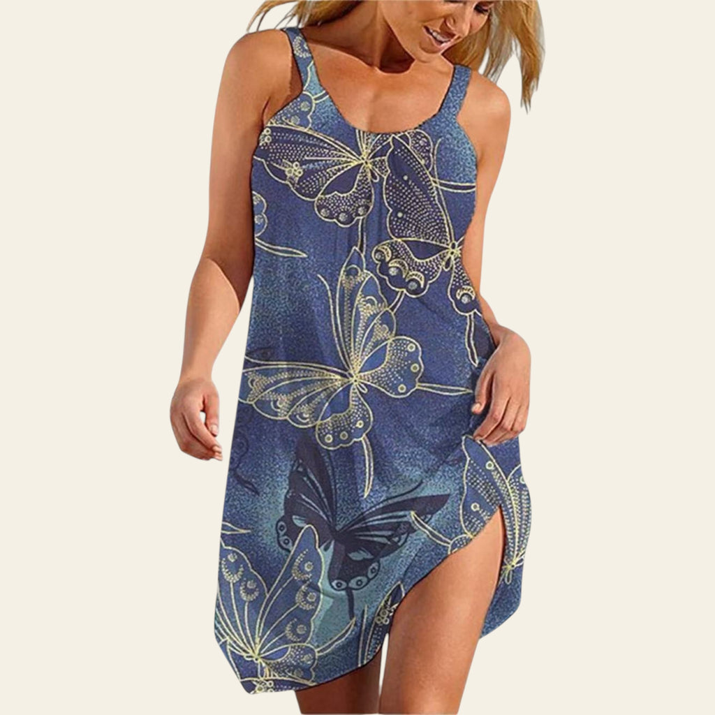 Woman wearing a sleeveless denim blue dress with white butterfly print, summer casual style