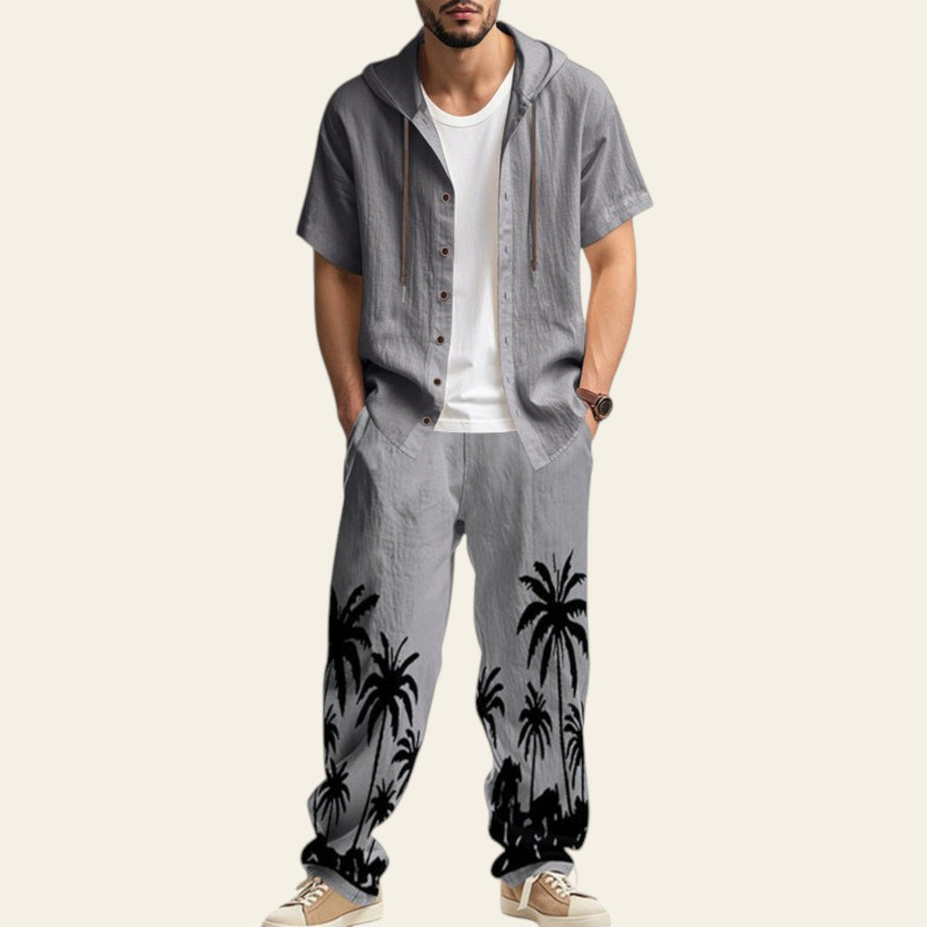 Man wearing a complete men's casual set with hooded short sleeve shirt and matching trousers in gray color