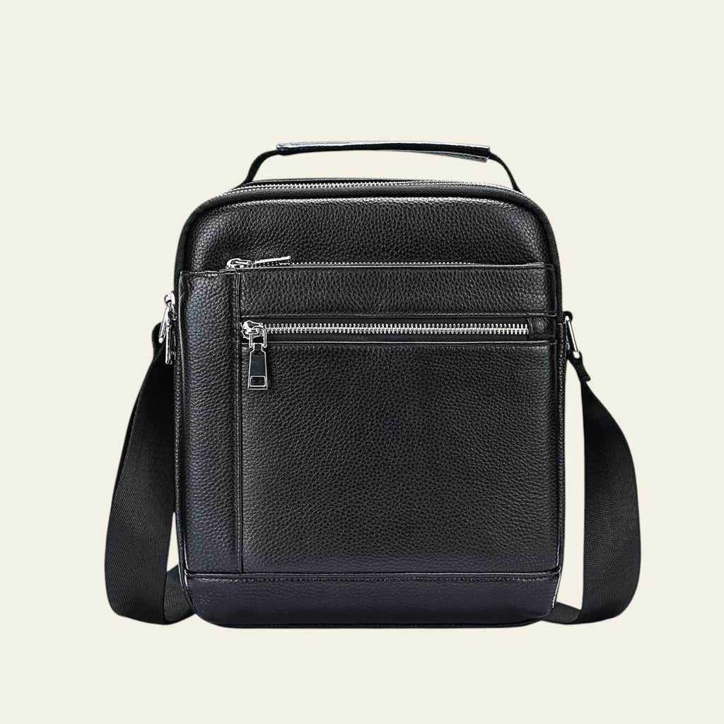 Black leather crossbody bag on a light gray background