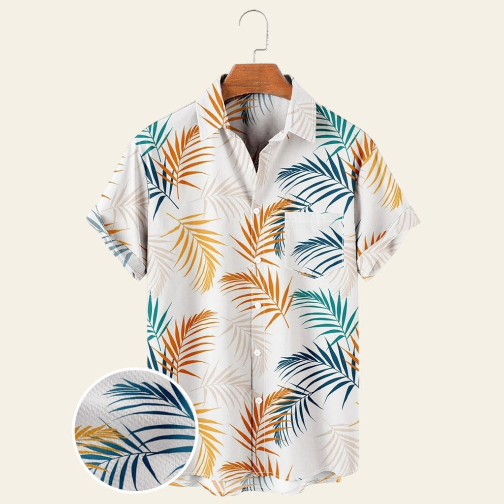 White men's short sleeve tropical shirt with blue and orange palm leaf print, wrinkle-free casual button-up shirt on hanger