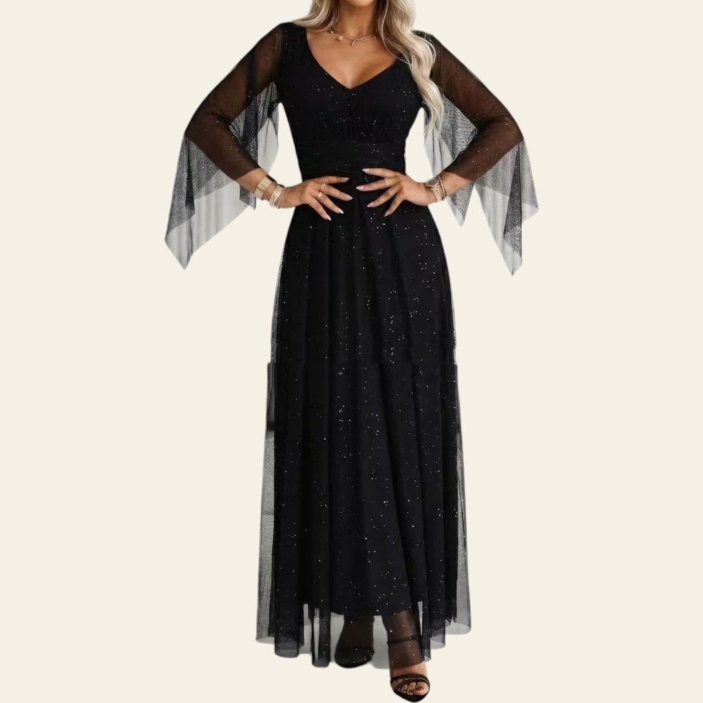Woman wearing a black long mesh dress with sheer sleeves