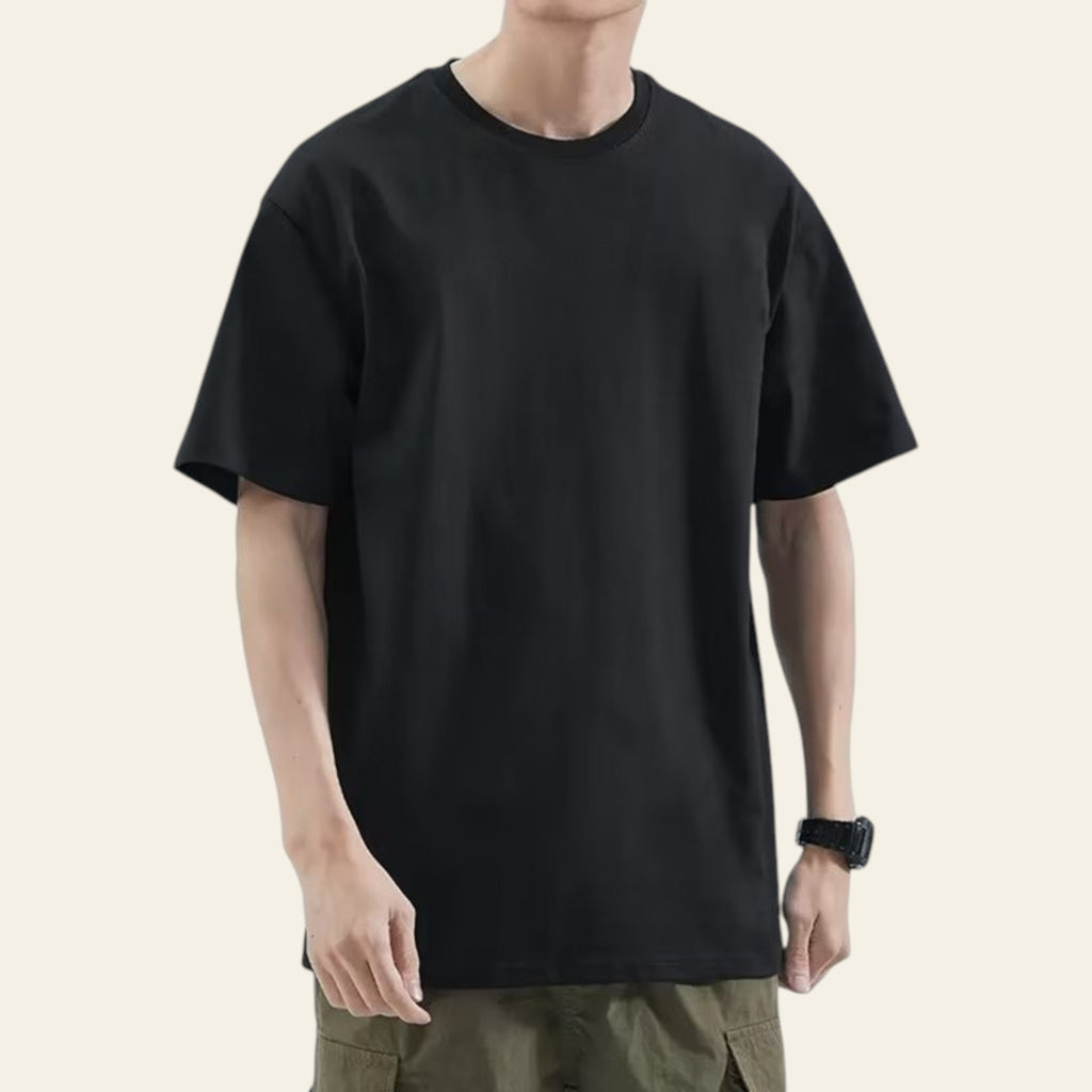 Man wearing a black loose fit solid color t-shirt
