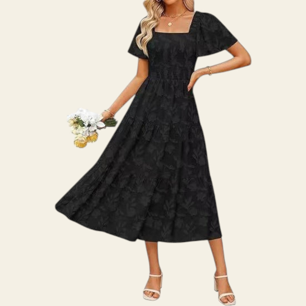 Woman wearing a black dress holding flowers on a white background