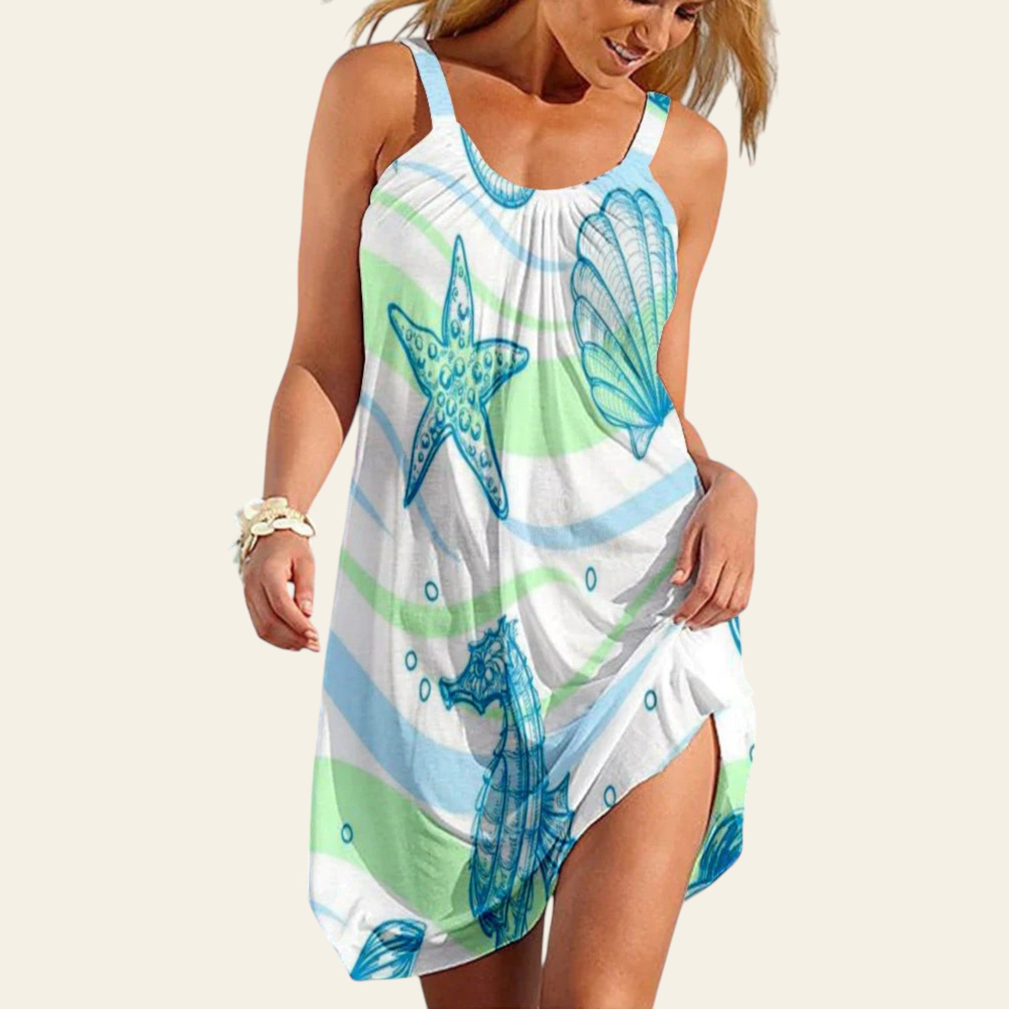 Woman wearing a sleeveless light blue and white dress with starfish and seashell print, beach summer style