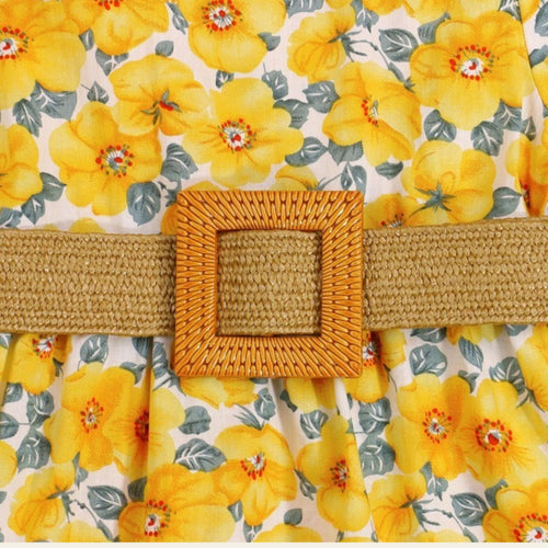Woven belt with a square buckle on a floral background