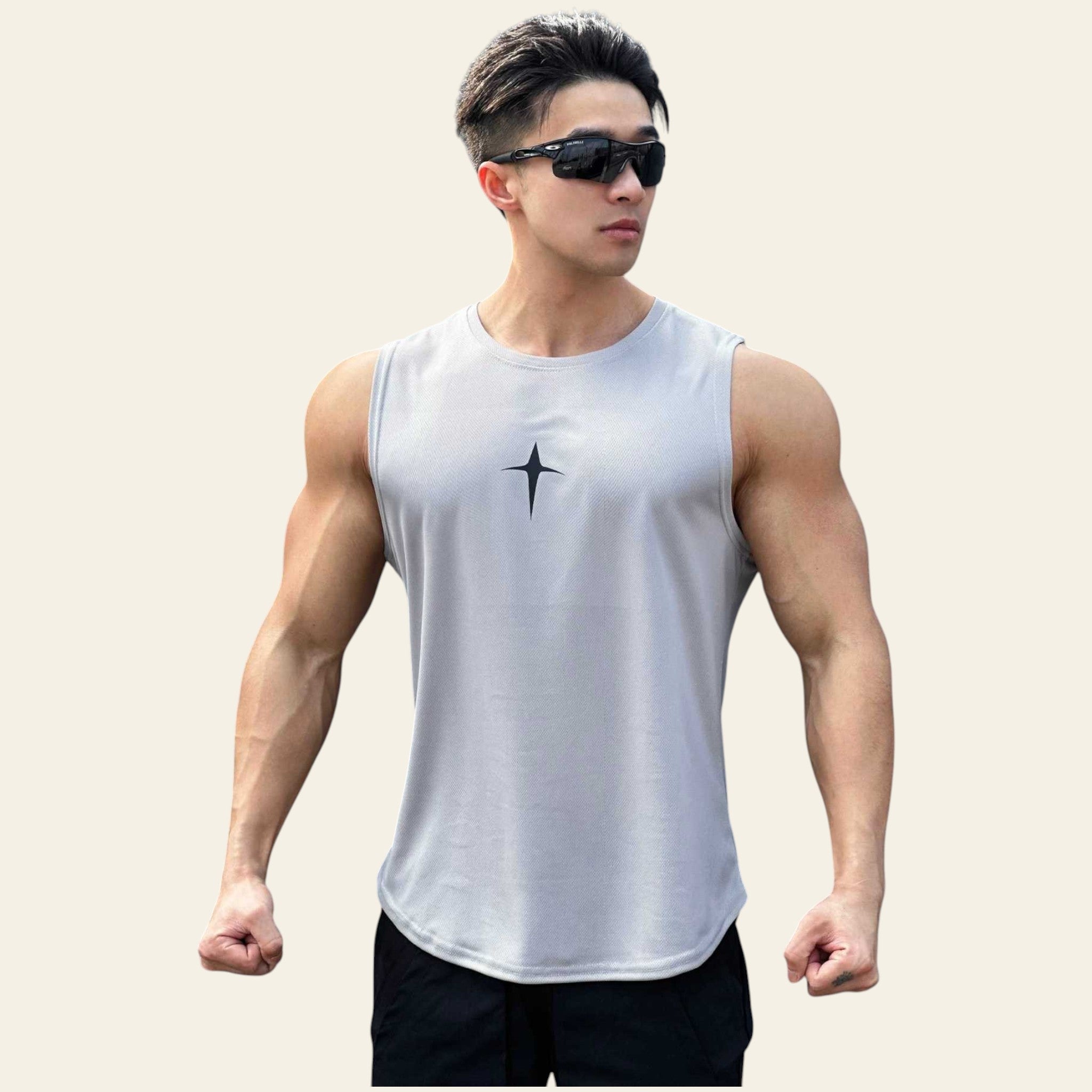 Man wearing a gray sleeveless crew neck slim-fit tank top