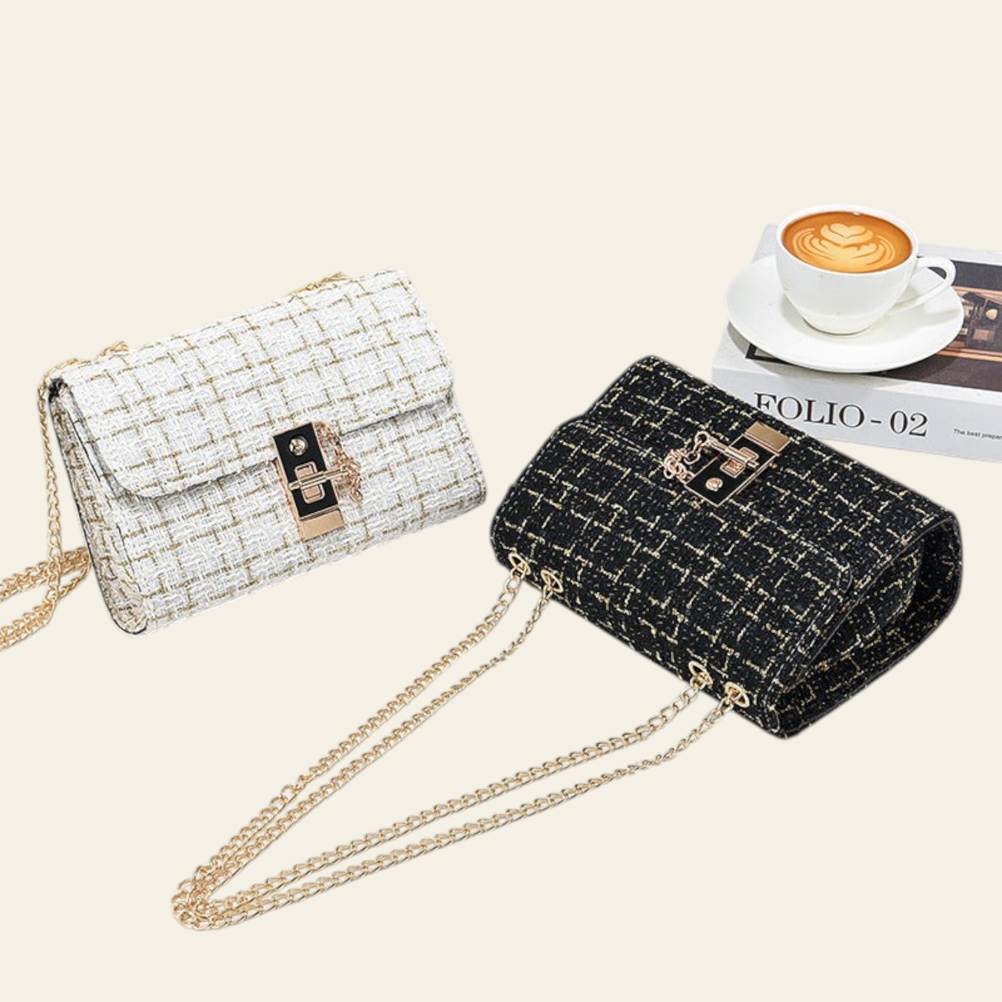 Two handbags, one white and one black, with gold chains on a light surface.