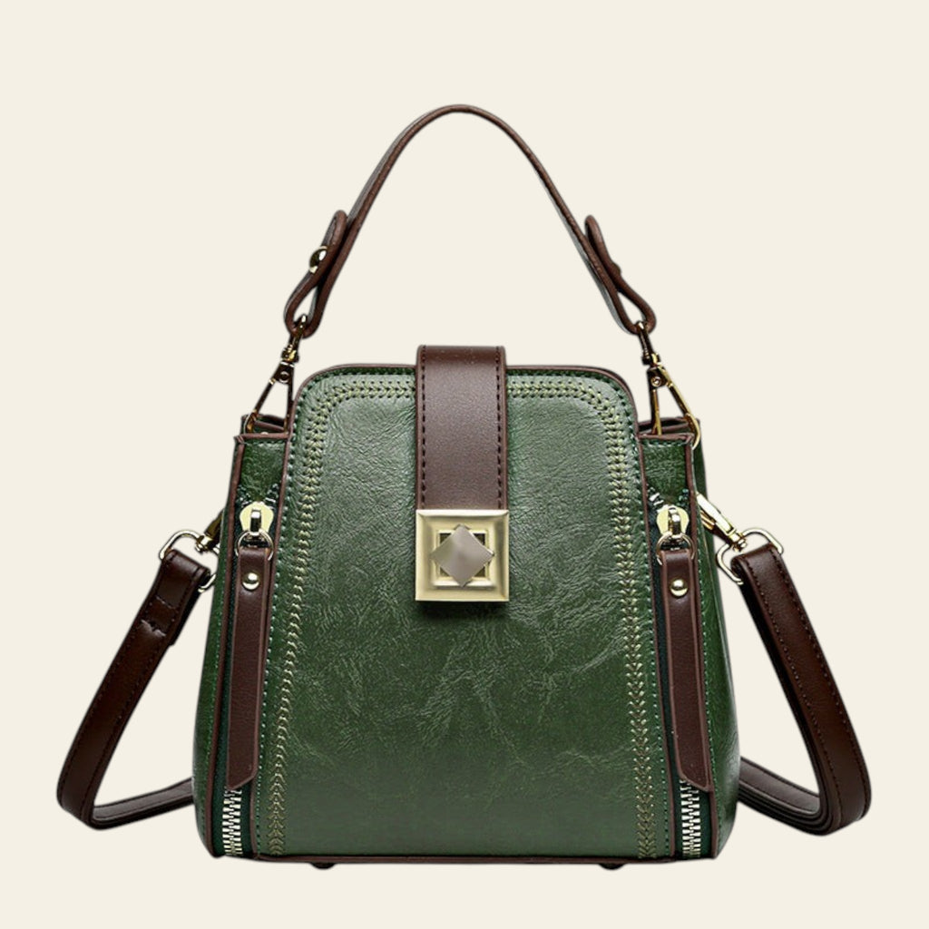 Green handbag with brown straps on a white background