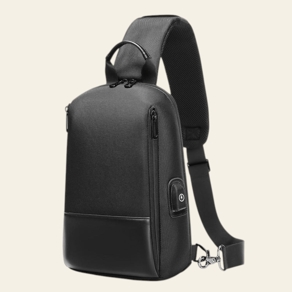 Black sling bag with USB port on a white background
