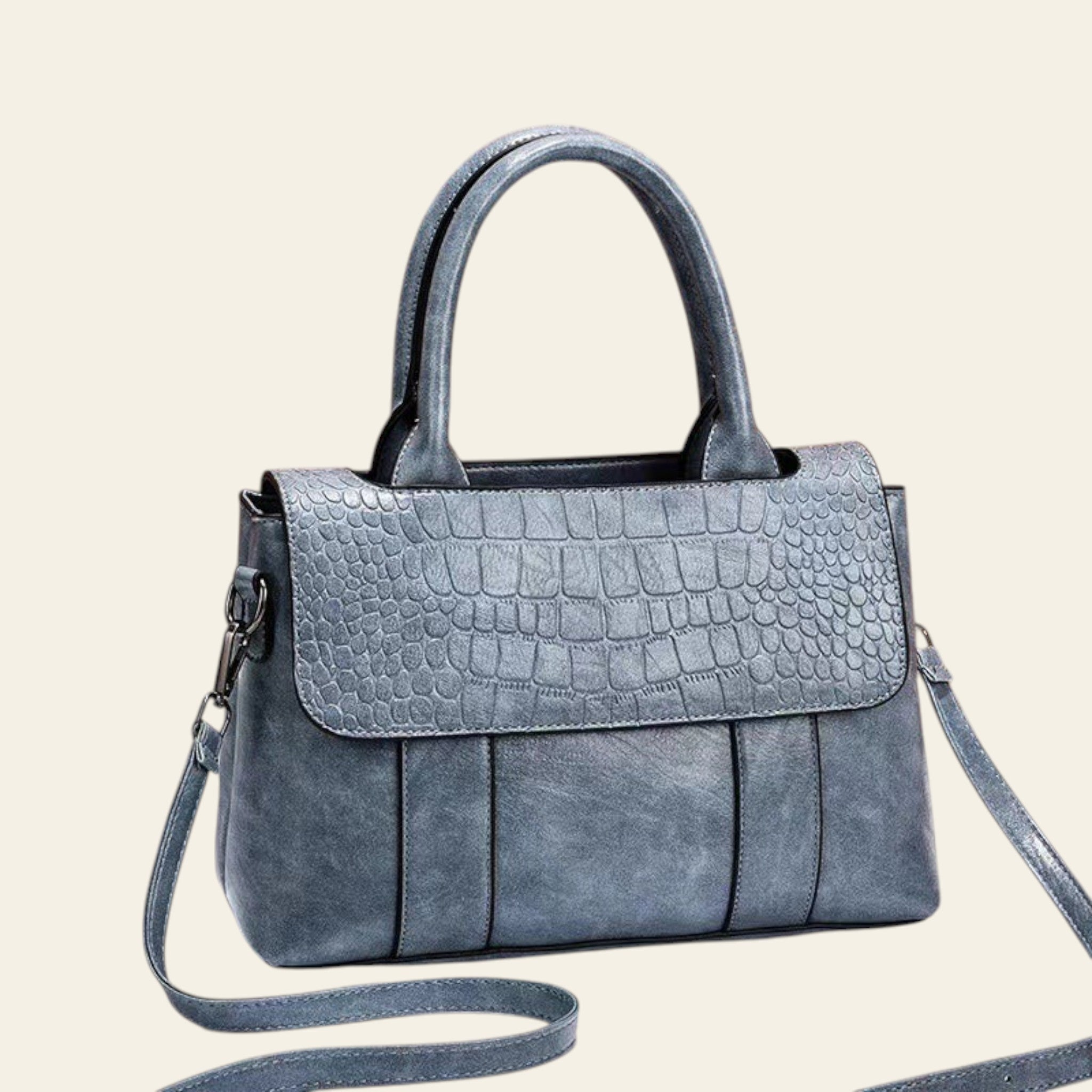 Blue textured handbag with a strap on a white surface and brown background