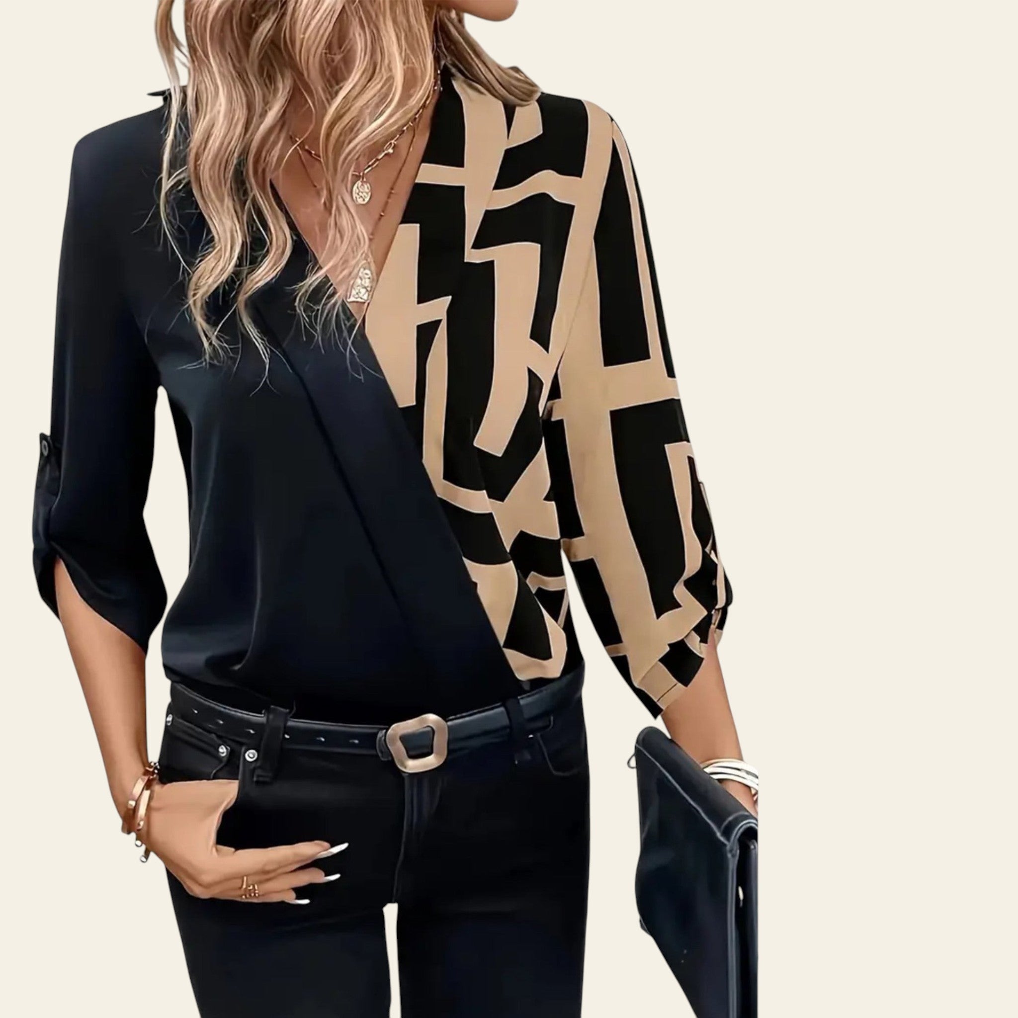 Woman wearing a black and beige patterned blouse with a black skirt, holding a clutch.